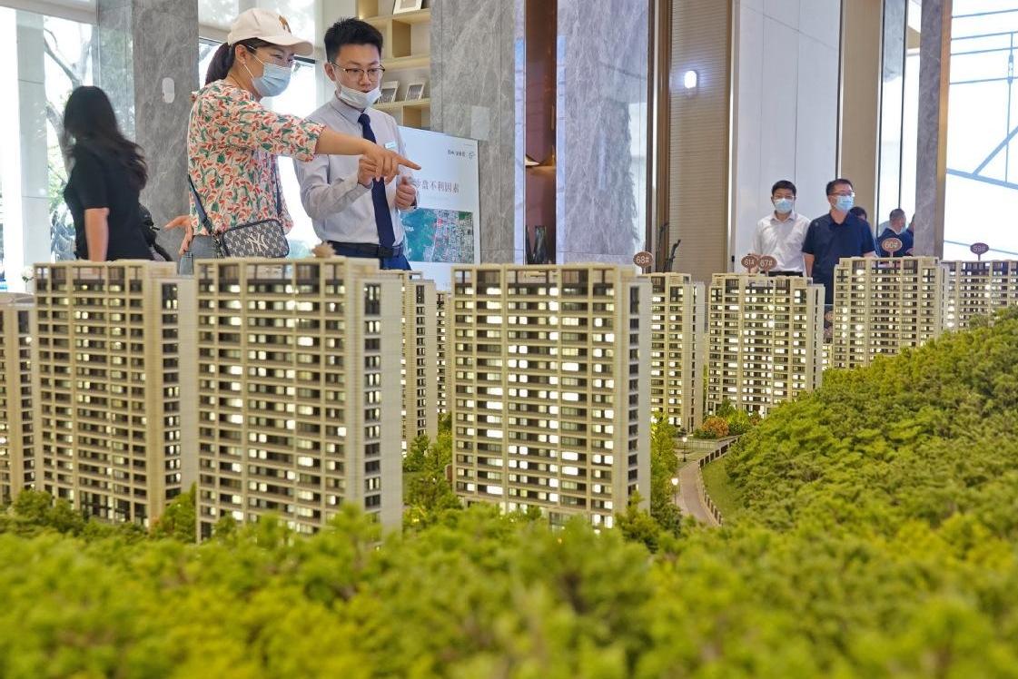 Potential homebuyers look at a residential property model in Fuyang, Anhui province.